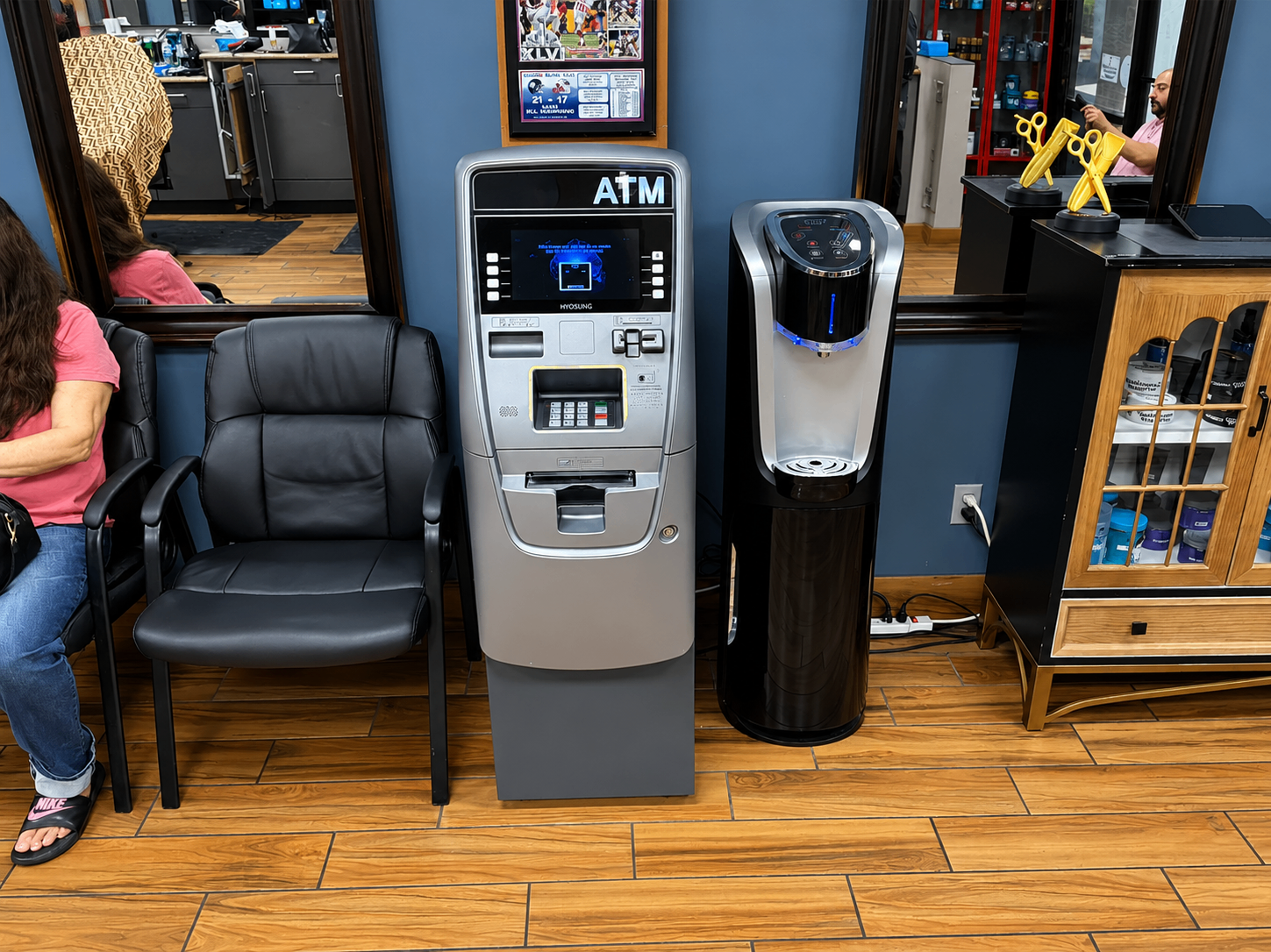 ATM and water station available inside Twins Barber Shop waiting area