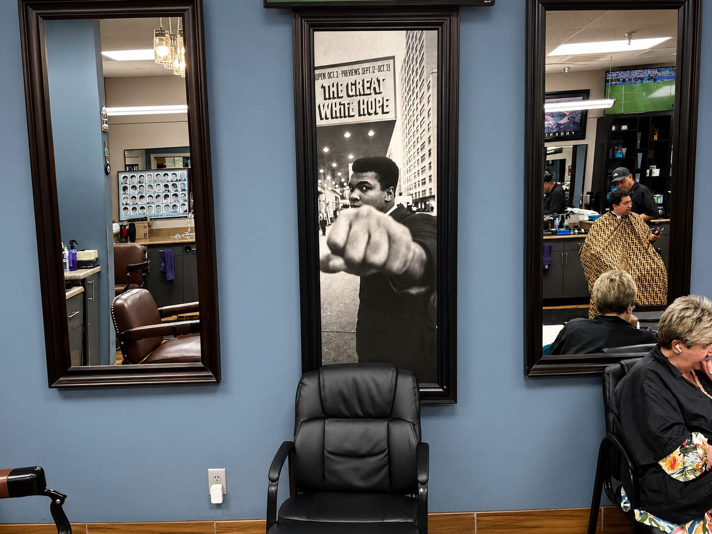 Barber station and mirror view inside Twins Barber Shop during a haircut